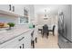 Cozy kitchen with stainless steel refrigerator and a dining area featuring a round table and chairs at 2151 Zelda Ne Dr, Atlanta, GA 30345