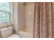Bathroom with a tub and shower combination with white subway tiles and a printed shower curtain at 3157 Oakdale Rd, Hapeville, GA 30354
