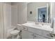 Bright bathroom featuring a white subway tile shower, white vanity, and a large mirror over the sink at 3157 Oakdale Rd, Hapeville, GA 30354