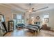 Bedroom featuring natural lighting, tray ceilings, neutral colors, and hardwood floors at 3157 Oakdale Rd, Hapeville, GA 30354
