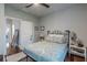 Cozy bedroom with a patterned duvet, iron bed frame, and hardwood floors at 3157 Oakdale Rd, Hapeville, GA 30354