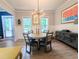 Bright dining room featuring modern chandelier, art and large windows at 3157 Oakdale Rd, Hapeville, GA 30354