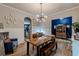Cozy dining room with ample seating, stylish light fixture, and hardwood floors for gatherings at 3157 Oakdale Rd, Hapeville, GA 30354