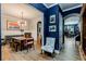 Elegant dining room featuring hardwood floors, wainscoting, and an eye-catching modern chandelier at 3157 Oakdale Rd, Hapeville, GA 30354