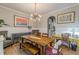 Bright dining area with a wooden table set, stylish lighting, and an adjacent view into the kitchen at 3157 Oakdale Rd, Hapeville, GA 30354