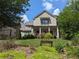 Beautiful two-story home with manicured lawn and charming front porch with decorative address sign at 3157 Oakdale Rd, Hapeville, GA 30354