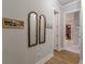 Hallway view showing decorative wall art, mirrors, and access to closet at 3157 Oakdale Rd, Hapeville, GA 30354
