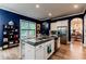 Well-lit kitchen with stainless steel appliances, a large island with granite countertops and a view of the dining room at 3157 Oakdale Rd, Hapeville, GA 30354