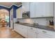 Modern kitchen features white cabinets and granite countertops at 3157 Oakdale Rd, Hapeville, GA 30354