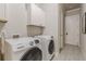 Laundry room featuring modern washer and dryer units and storage cabinets at 3157 Oakdale Rd, Hapeville, GA 30354