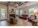 Cozy living room with a fireplace, neutral tones, and views of the outdoor space at 3157 Oakdale Rd, Hapeville, GA 30354