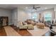Spacious living room with hardwood floors, lots of windows, and a ceiling fan at 3157 Oakdale Rd, Hapeville, GA 30354
