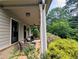 Relaxing covered porch with comfortable seating and views of the lush garden at 3157 Oakdale Rd, Hapeville, GA 30354