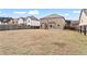 Large backyard featuring a lawn area, houses, and wood privacy fence at 4102 Dinmont Chase, Atlanta, GA 30349