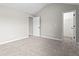 Spacious bedroom with neutral walls and carpet next to doorways to closet and hallway at 4102 Dinmont Chase, Atlanta, GA 30349