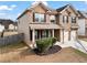 View of a well-maintained home with a brick facade, complemented by a green lawn and a fenced backyard at 4102 Dinmont Chase, Atlanta, GA 30349