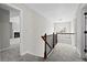 Spacious hallway with gray carpet flooring and decorative railing at 4102 Dinmont Chase, Atlanta, GA 30349