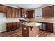 Kitchen with stainless appliances, an island, and dark wood cabinets at 4102 Dinmont Chase, Atlanta, GA 30349