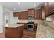 Open kitchen area with granite countertops and stainless appliances at 4102 Dinmont Chase, Atlanta, GA 30349