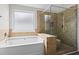 Beautiful main bathroom featuring a soaking tub and separate glass shower at 4102 Dinmont Chase, Atlanta, GA 30349