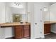 Main bathroom featuring dual vanities with granite countertops and dark wood cabinets at 4102 Dinmont Chase, Atlanta, GA 30349