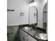 Modern bathroom features sleek fixtures, a granite countertop and stylish mosaic backsplash, providing an elegant design at 4830 Rebel Nw Trl, Sandy Springs, GA 30327