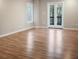 Bright bedroom features wood floors, a window, and french doors to the deck at 4830 Rebel Nw Trl, Sandy Springs, GA 30327