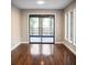 Bedroom features hardwood flooring and access to the deck, offering a seamless indoor-outdoor flow at 4830 Rebel Nw Trl, Sandy Springs, GA 30327
