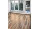 Bright bedroom showcases new laminate flooring, natural light from windows, and a glass patio door at 4830 Rebel Nw Trl, Sandy Springs, GA 30327
