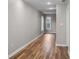 Bright hallway with natural light highlights newly installed hardwood floors and neutral paint at 4830 Rebel Nw Trl, Sandy Springs, GA 30327