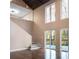 Open-concept living room featuring high ceilings, large windows, and access to a deck at 4830 Rebel Nw Trl, Sandy Springs, GA 30327
