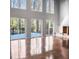Bright living room featuring dark hardwood floors, a modern fireplace, and walls of windows at 4830 Rebel Nw Trl, Sandy Springs, GA 30327