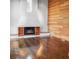 Bright living room featuring dark hardwood floors, a modern fireplace, wooden wall and natural light at 4830 Rebel Nw Trl, Sandy Springs, GA 30327