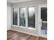 Sun-filled living room featuring large windows with views of backyard scenery at 4830 Rebel Nw Trl, Sandy Springs, GA 30327