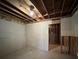 Unfinished basement space with partial drywall and exposed ceiling beams awaiting your personalization at 3713 Cameron Hills Pl, Ellenwood, GA 30294