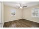 Comfortable bedroom with modern flooring, ceiling fan, and ample natural light from two windows at 1438 Joy Ln, Decatur, GA 30032