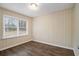 Cozy bedroom with classic hardwood floors, paneled walls, and a large window for natural light at 1438 Joy Ln, Decatur, GA 30032