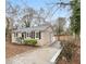 An angled view of a single-story home with front yard and concrete walkway to side door at 1438 Joy Ln, Decatur, GA 30032