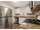 Modern kitchen with stainless steel appliances, granite countertops, and white cabinets at 1438 Joy Ln, Decatur, GA 30032