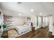 Well-lit bedroom with wood floors, decorative wall art, and a view of the bathroom at 2003 Cogar Dr, Decatur, GA 30032