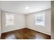 Bright, neutral bedroom with hardwood floors and two large windows at 2003 Cogar Dr, Decatur, GA 30032