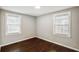 Neutral bedroom with hardwood floors and two large windows at 2003 Cogar Dr, Decatur, GA 30032