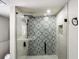 Detailed view of the tiled shower with glass enclosure and modern fixtures at 2003 Cogar Dr, Decatur, GA 30032