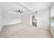 A spacious bedroom with a fan, tray ceiling, and doorway view of the bath at 96 Trailview Lane Ln, Hiram, GA 30141