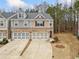 Attractive townhome with a two-car garage, set against a backdrop of mature trees at 96 Trailview Lane Ln, Hiram, GA 30141