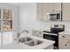 View of the kitchen island with a stainless sink, range, microwave, and stainless steel refrigerator at 96 Trailview Lane Ln, Hiram, GA 30141