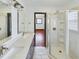 Bathroom featuring double vanity sinks, walk-in shower, and views through doorway to bedroom at 1017 Martin Luther King Jr Dr, Atlanta, GA 30314