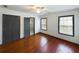 Spacious bedroom with two windows, ceiling fan, hardwood floors, and painted trim at 1017 Martin Luther King Jr Dr, Atlanta, GA 30314