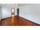 Bedroom showcasing hardwood floors, neutral walls, and a view into the bathroom at 1017 Martin Luther King Jr Dr, Atlanta, GA 30314