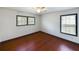 Bedroom featuring hardwood floors, natural light from two windows, and simple decor at 1017 Martin Luther King Jr Dr, Atlanta, GA 30314